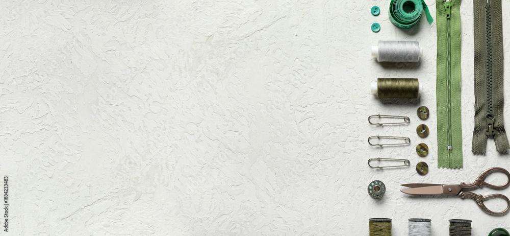 Obraz premium Different tailor's supplies with measuring tape on white grunge background with space for text