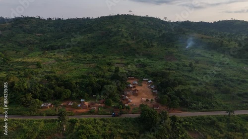 Wallpaper Mural aerial drone of authentic rural life of a Congolese settlement from above, featuring simple houses along a road winding through the wild African landscape Torontodigital.ca