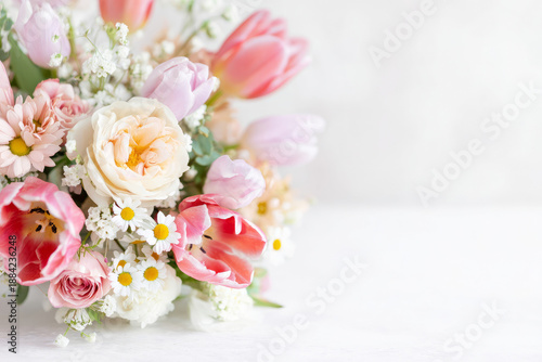 Elegant floral arrangement of tulips, roses, and daisies on white table, soft natural light, clean composition for International Women's Day greeting card and stock imagery