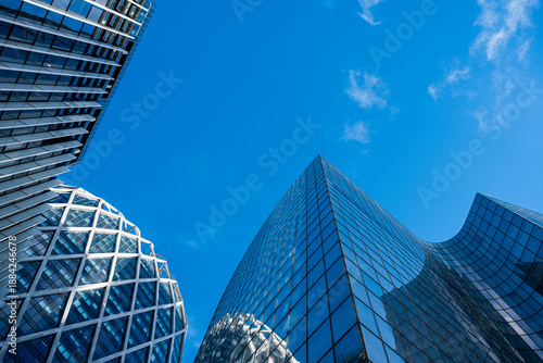 Glass skyscraper in city sky with modern corporate architecture and urban geometry from low perspective creating powerful business backdrop
