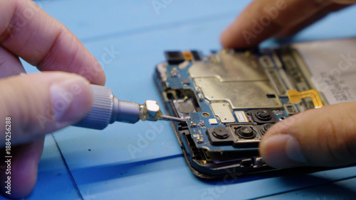 Photography Close up of hands repairing a broken smartphone screen