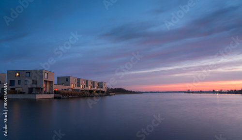 A colourful dawn in modern neighbourhood at the waterfront. Meerstad, the Netherlands.
