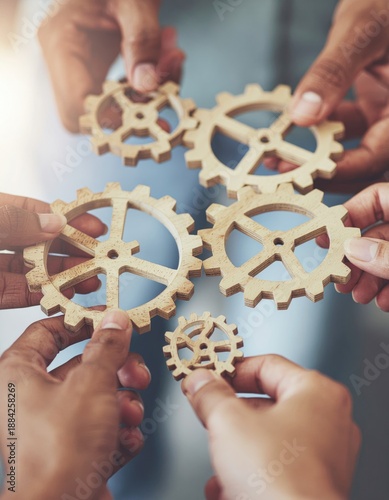  A dynamic image showing diverse hands connecting wooden gears, symbolizing teamwork and innovation in business