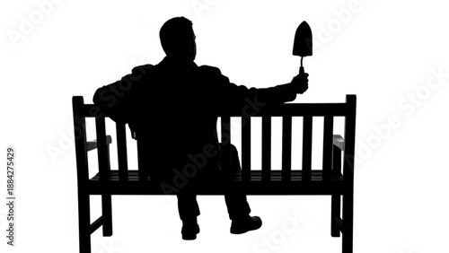 A solitary man in silhouette sits on a park bench, holding a small garden tool, embodying contemplation and the simple pleasure of cultivation and growth