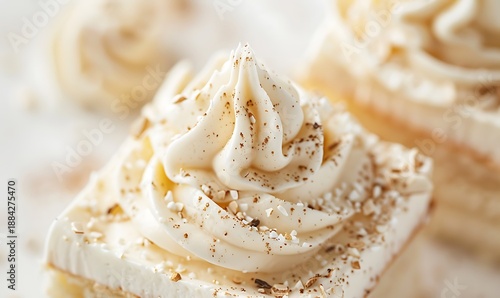 Refined vanilla pastry with creamy frosting and subtle gold accents in a clean presentation