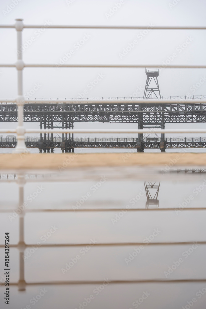 Fototapeta premium Huelva. Photo of the Tinto Wharf from the riverfront promenade. Very foggy winter day.