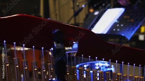 Musical instruments stand on spacious stage against auditorium. Hall contains large chimes and drums for performance during concert