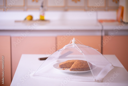 A freshly baked carrot cake on a kitchen table