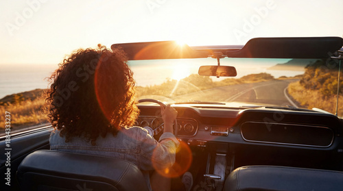 Wallpaper Mural Driving on a winding road by the ocean as the sun sets in the background over a quiet landscape Torontodigital.ca