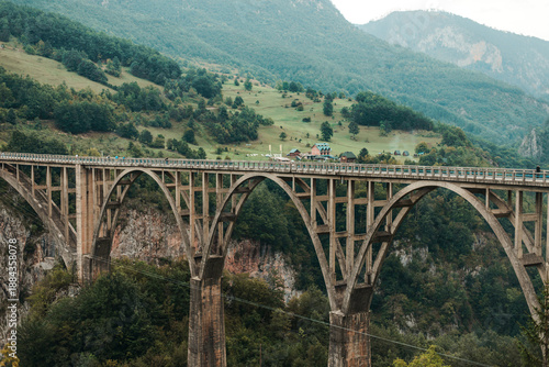 Concrete arch bridge spanning a deep mountain canyon