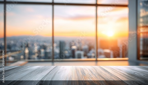 Wooden tabletop overlooks blurred city skyline at sunset