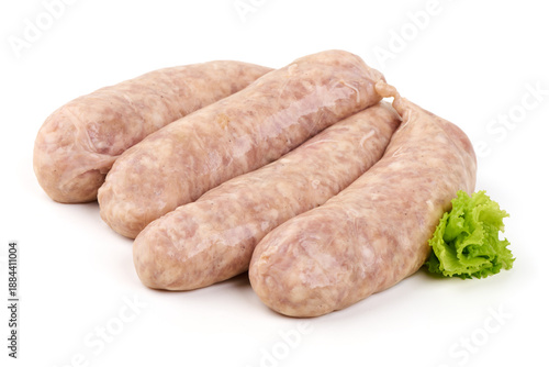 Raw pork sausages with natural casings, light pink color, displayed on a white surface with a leaf of lettuce, isolated on white background.