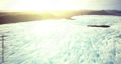 Sunlit ice field with lone ship navigating thawing pack ice, golden glare across wide frozen expanse, distant vessel silhouette on horizon, cold bright