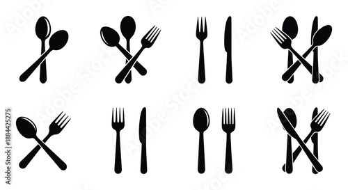 A collection of black silhouette cutlery forks spoons and knives arranged neatly
