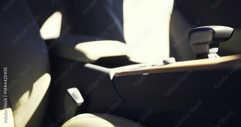 Fototapeta premium sunlit beige car interior close up revealing leather upholstery, center console and seatbelt buckle bathed in warm morning glow soft shadows emphasize texture