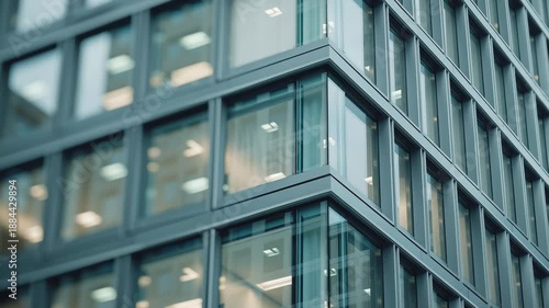 Modern glass office tower facade with shallow dof and slow dolly in