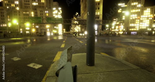 Slika na platnu Empty urban street at night, dimly lit sidewalk and lamppost casting warm glow,