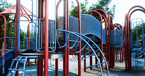 Foto Vibrant urban playground with metal slides and climbing frames, blue and red str