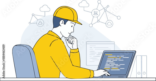 A man in a yellow hard hat working on a laptop with code on the screen in an office setting from a side viewpoint