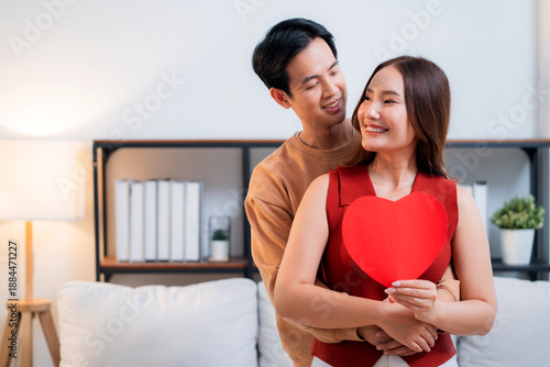 Wallpaper Mural Portrait happy asian couple holding heart card celebrating Valentine's Day or anniversary together at home, smiling feeling love, romantic relationship, February 14 holiday, happiness and romance. Torontodigital.ca