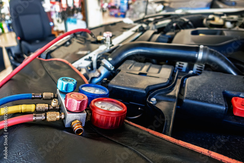 A/C Manifold Gauges Set. Check pressure and leak for use air conditioning systems. Recharging car air conditioner with refrigerant using grade gear with separate gauges to monitor pressure in system.