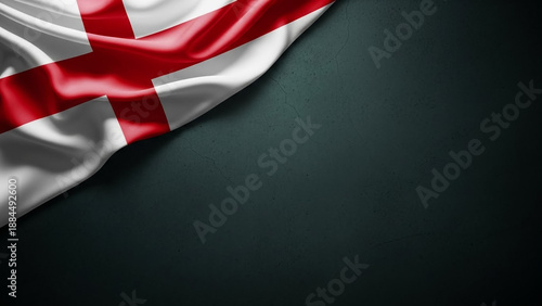 A flowing silk flag of England with the red St. George's Cross rests on a dark, textured background.