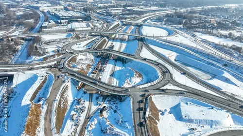 Krakow, Poland. Grebalow highway and tramway interchange under construction in winter. Partially open for traffic. Last fragment of ring road around Krakow, Aerial time lapse. State in January 2026