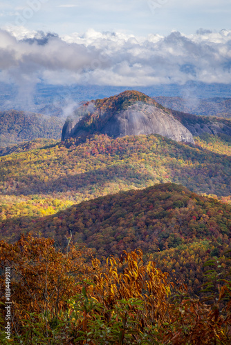 Color photo of Looking Glass Rock from the Blue Ridge Parkway in the fall in beautiful dappled lighting