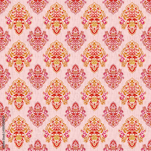 Ethnic damask seamless pattern with bohemian floral motifs and intricate mandala ornaments on pink textured background for textile, wallpaper, and commercial fashion design