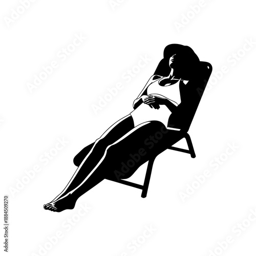 The silhouette of a woman sunbathing on the beach