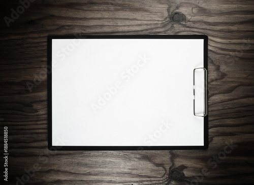 Clipboard with blank A4 paper on wooden surface with plenty of copy space. Branding stationery mockup. Flat lay.