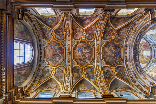 The Church of San Nicola alla Carita in Naples, Italy with ornate frescoed ceilings, marble columns in baroque style.Ornate Baroque ceiling frescoes by Francesco Solimena