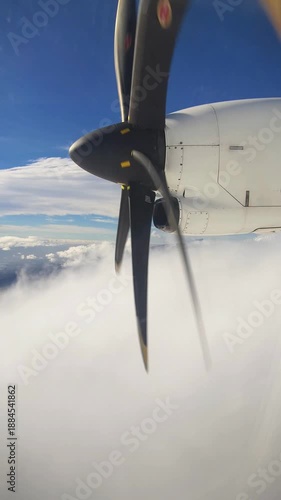 View from the airplane window on the propeller while flying above the clouds	