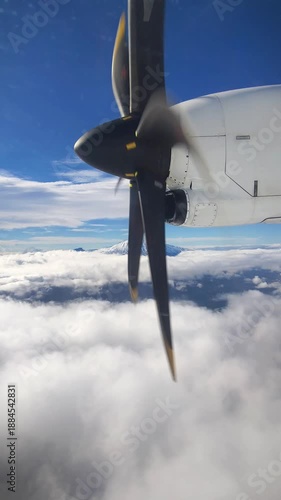 View from the airplane window on the propeller while flying above the clouds