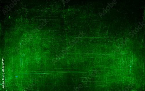 Dark green decorative abstract background. Texture of plastered concrete wall. Grunge background. The combination of the texture of a grainy rough surface and dark turquoise color