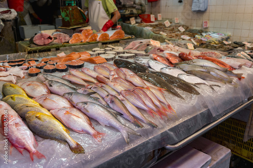 Wallpaper Mural A vibrant assortment of fresh whole fish and thick salmon steaks is meticulously arranged on a bed of crushed ice at a bustling wet market in Hong Kong. Torontodigital.ca