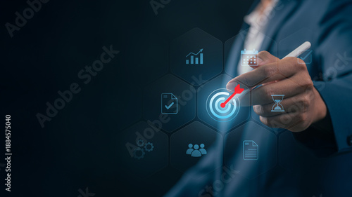 Goal setting and strategic focus using digital interface. businessman selecting target icon and strategy dashboard. strategic planning, performance tracking and digital business management for success