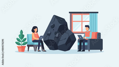 Two people work on laptops in a room with a large rock