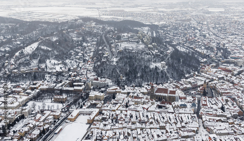 Brasov, Transylvania. Romania. Panoramic view of the old town and Council Square in the winter time,
