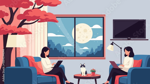 Two women with laptops and a cat relax indoors at night