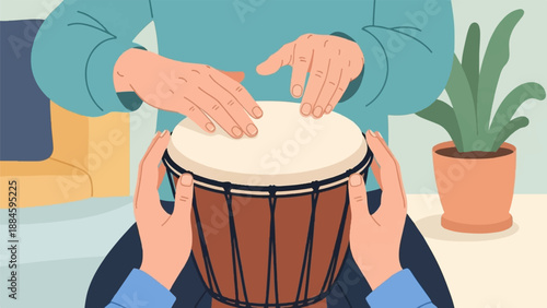 Two people play a drum with a plant in the background