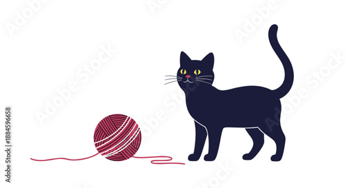 Playful black cat stands near a ball of pink yarn on a plain white background, capturing a simple and charming domestic moment.