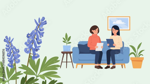 Two women sitting on a couch discussing documents in a room with plants