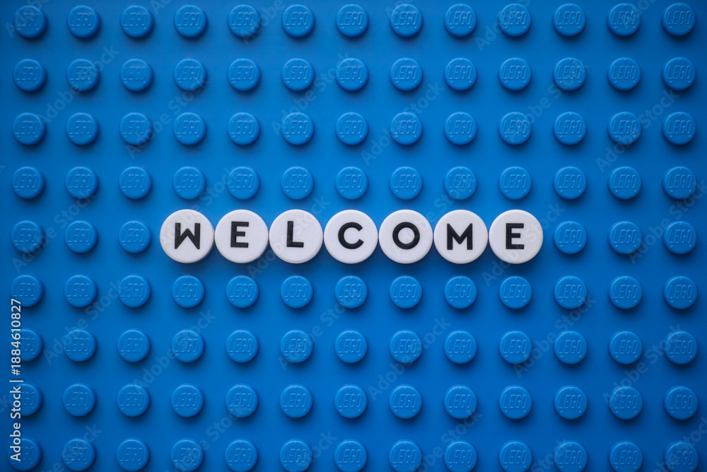Fototapeta premium Tambov, Russian Federation - January 19, 2026 The word Welcome on a blue Lego baseplate. The scene is made out of Lego dots.
