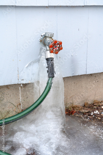water leak from outdoor faucet frozen into ice © nd700