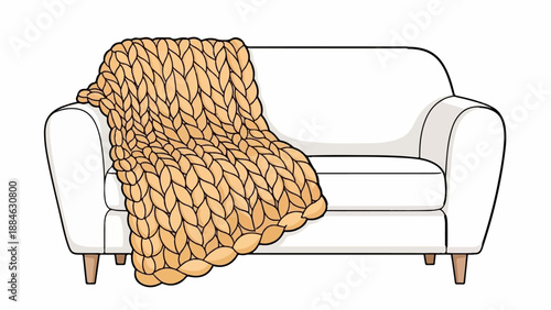 A cozy, oversized knitted blanket draped over a plush white sofa