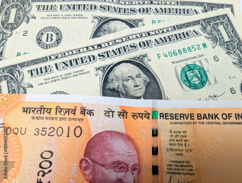 Photography close up of us dollar bills and indian 200 rupee note finance exchange rates eco