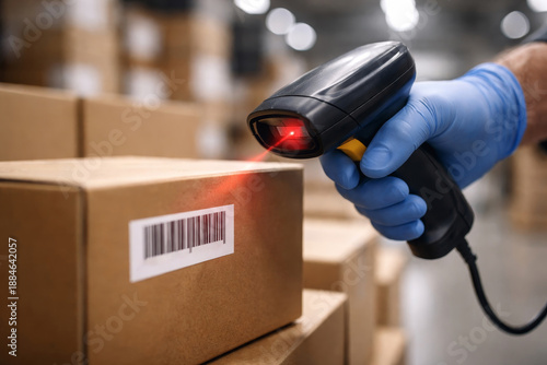 Man with blue glove scanning barcode on cardboard box. Warehouse inventory management and logistics concept. Distribution center and shipping process.