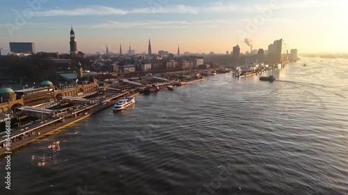 Aerial drone footage of beautiful sunrise over the St. Pauli Landungsbrücken in Hamburg