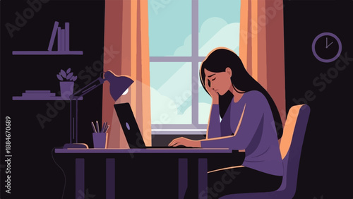 Woman at desk looking tired, working on laptop at sunset